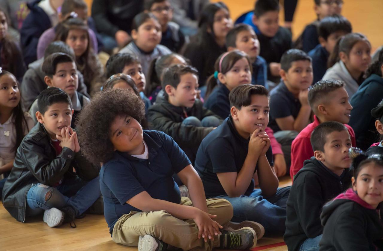 Children watch a host and pianist at a Cliburn in the Classroom program